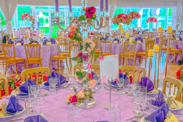Room setting of tables decorated for a wedding dinner