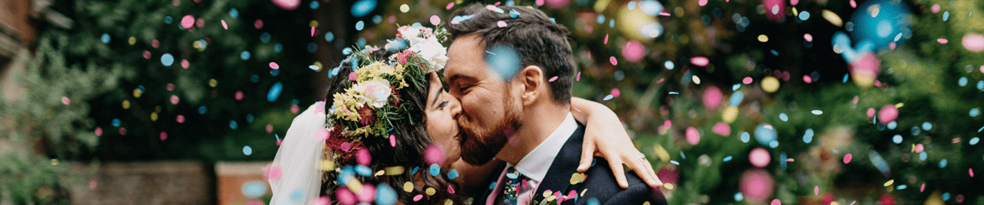 Couple kissing with confetti falling